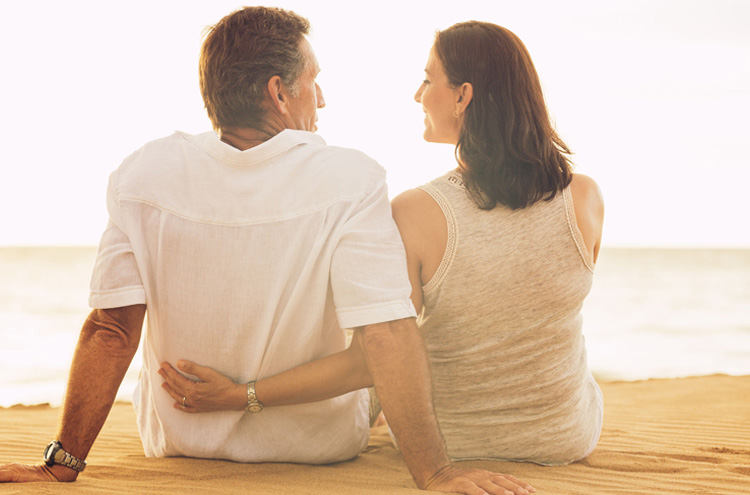 Happy married couple on the beach - What is the secret to a great marriage?